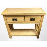 A contemporary oak two drawer side table,