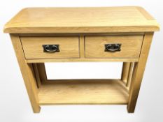 A contemporary oak two drawer side table,