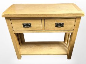 A contemporary oak two drawer side table,