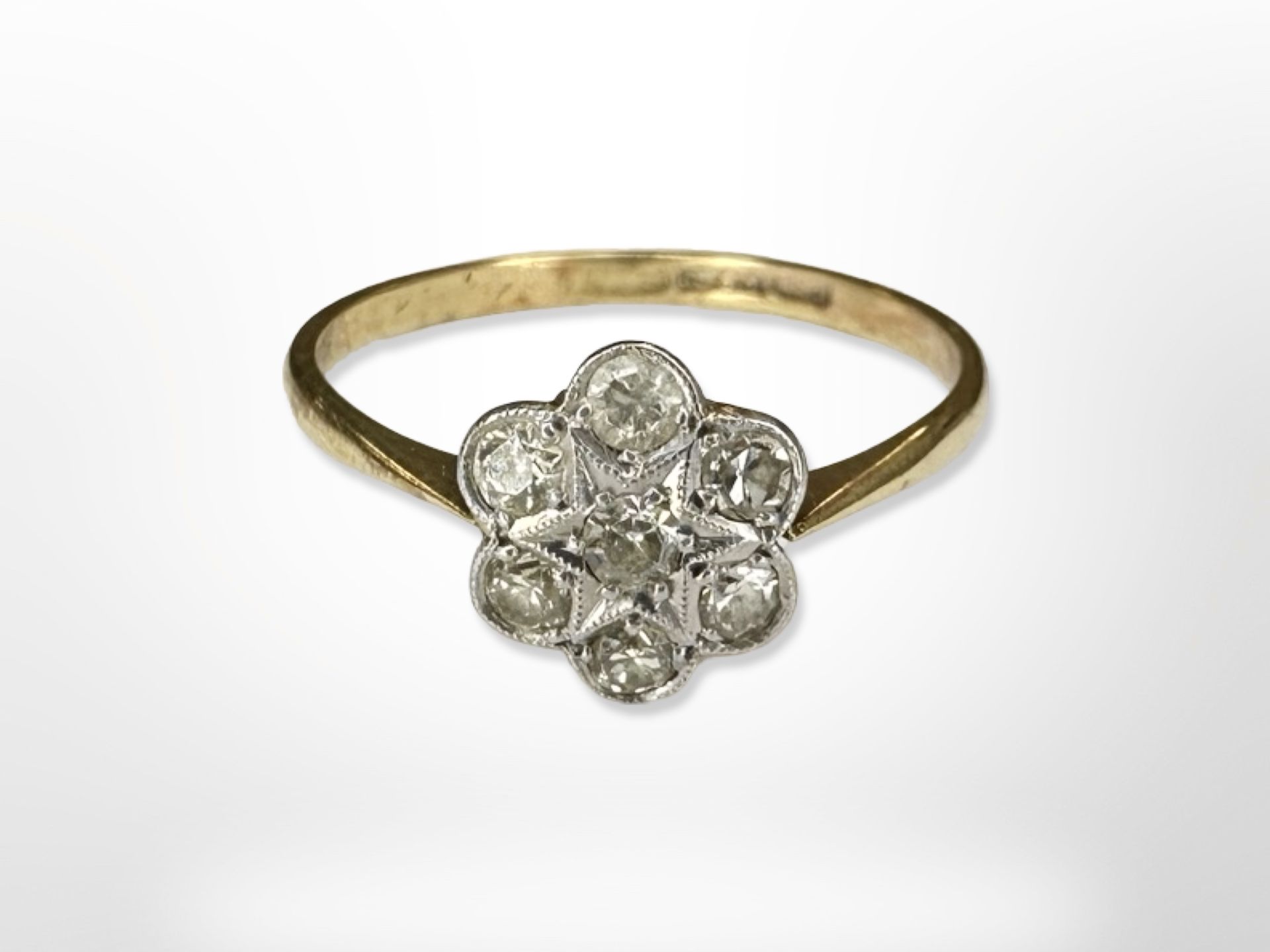 An 18ct yellow gold diamond set floral cluster ring, size N/O. CONDITION REPORT: 1.