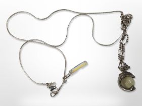 A silver-mounted crystal drop pendant on chain,