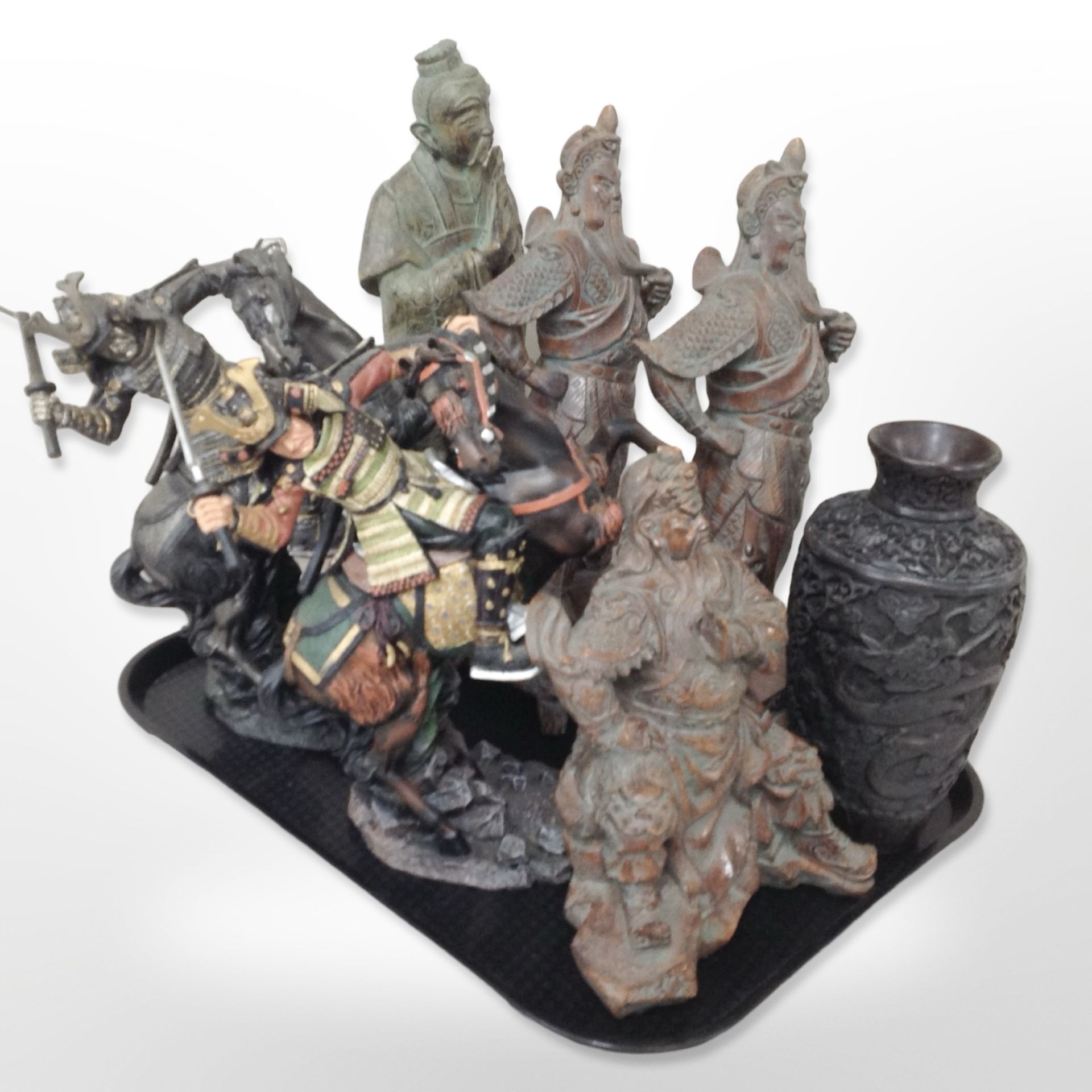 A group of oriental cast-resin figures of Chinese warriors and samurai on horseback,