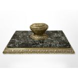 An ornate brass and green marble desk weight, length 20 cm.