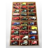 A collection of Days Gone diecast delivery vans on two wooden shelves.