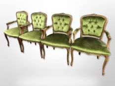 A set of four carved salon armchairs in green studded fabric