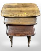 An Ercol stained elm high-gloss nest of three tables, width 57cm.