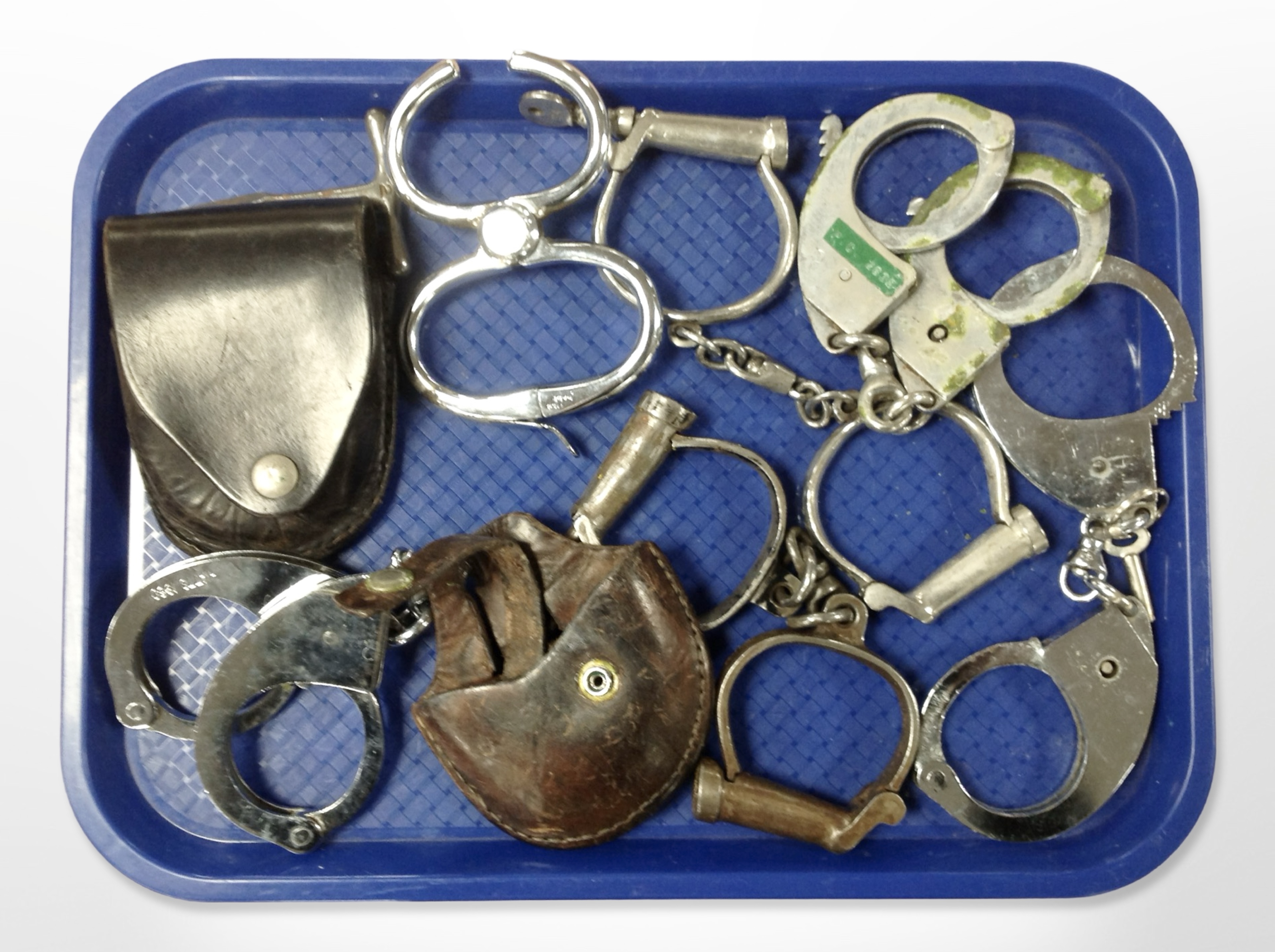 A group of antique and later handcuffs.