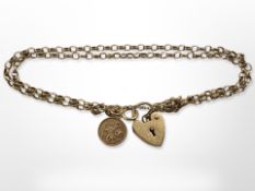 A 9ct yellow gold double strand bracelet with heart padlock CONDITION REPORT: 5.3g.