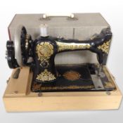 A Jones hand sewing machine in box.