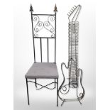 A wrought iron high back chair and a metal CD rack in the form of a guitar,