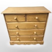 A contemporary pine five drawer chest,