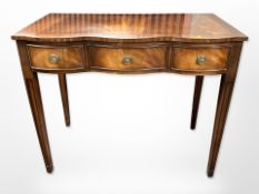 A reproduction mahogany serpentine front hall table,