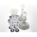 Two crystal ship's decanters, a set of four wine flutes, and nine further glasses.