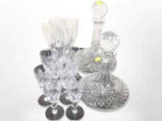 Two crystal ship's decanters, a set of four wine flutes, and nine further glasses.