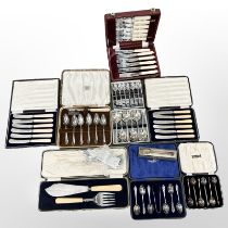 A cased set of six silver coffee spoons and eight further boxed cutlery sets