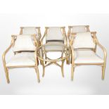 A set of five bamboo armchairs and matching glass-topped occasional table.