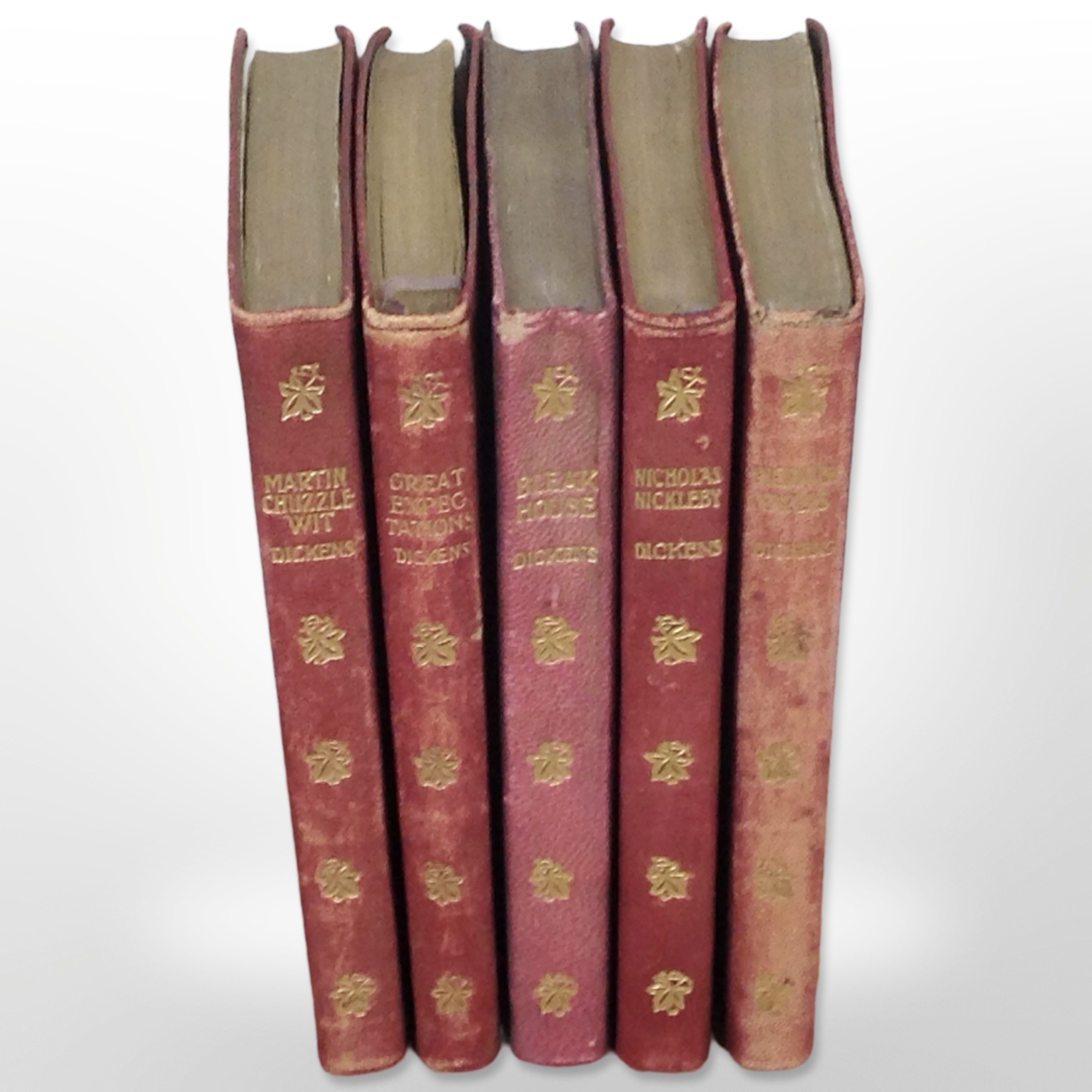 Five Charles Dickens volumes published by Thomas Nelson & Sons, in gilt leather binding.