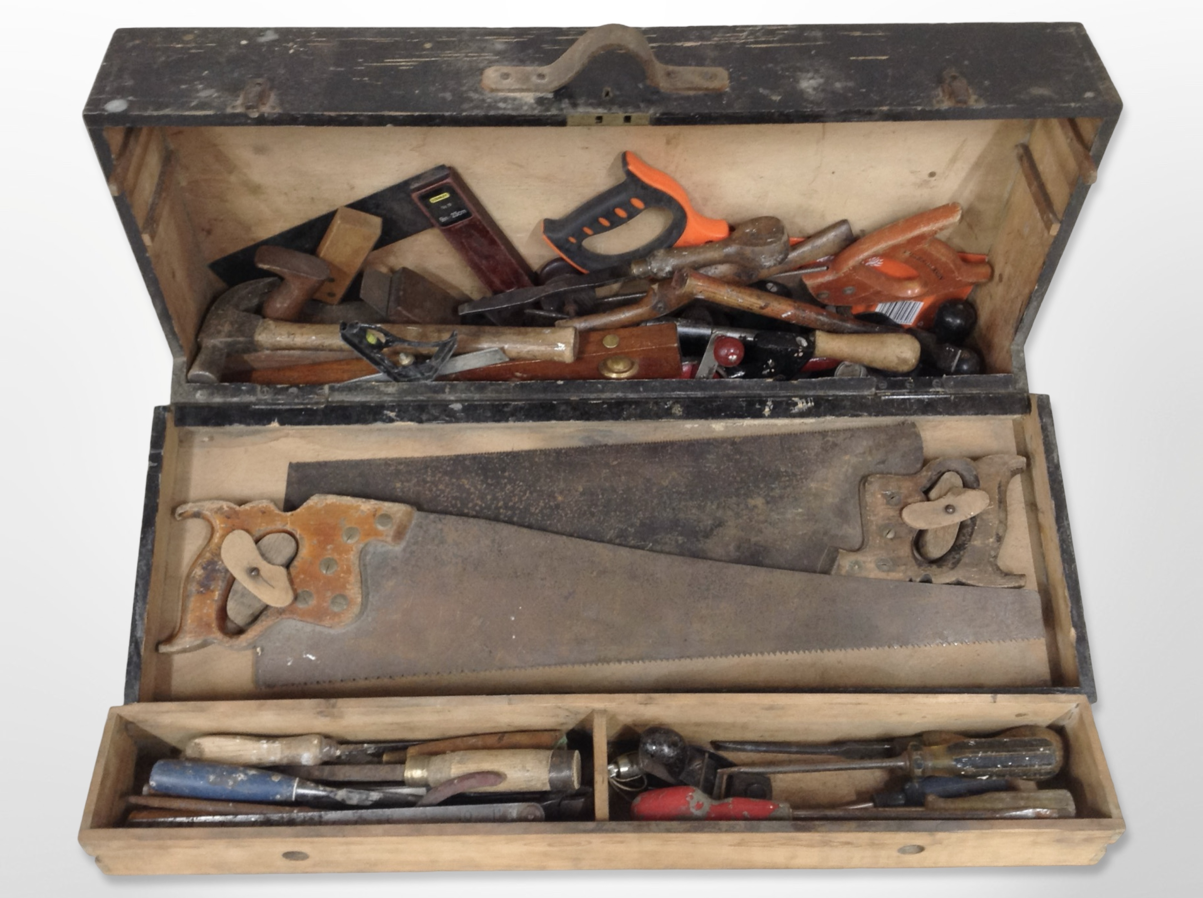 An antique joiner's tool box containing carpentry tools.