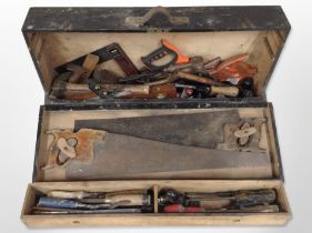 An antique joiner's tool box containing carpentry tools.