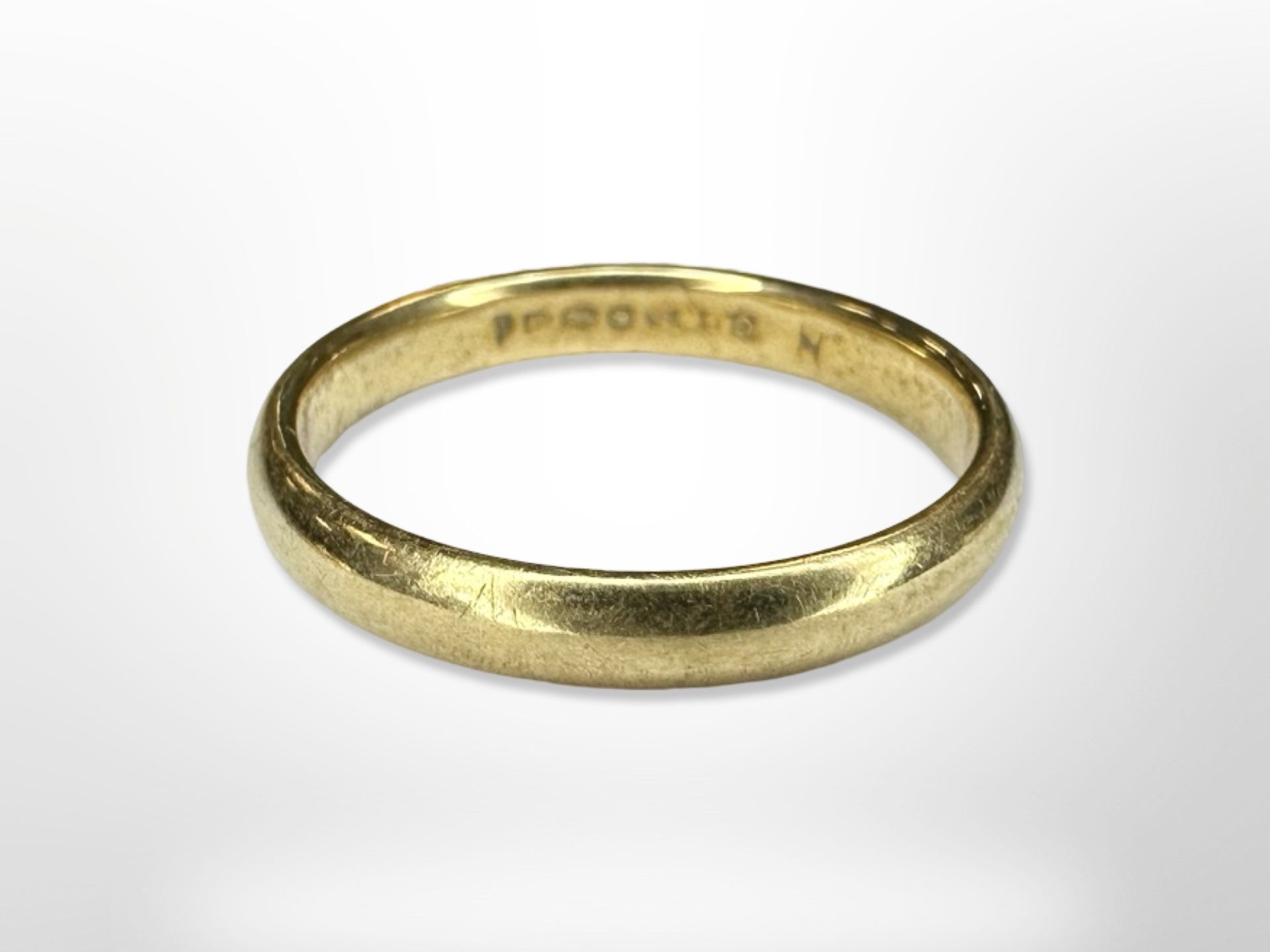 An 18ct yellow gold band ring, size N. CONDITION REPORT: 3.6g.