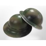 Two 20th-century military helmets.