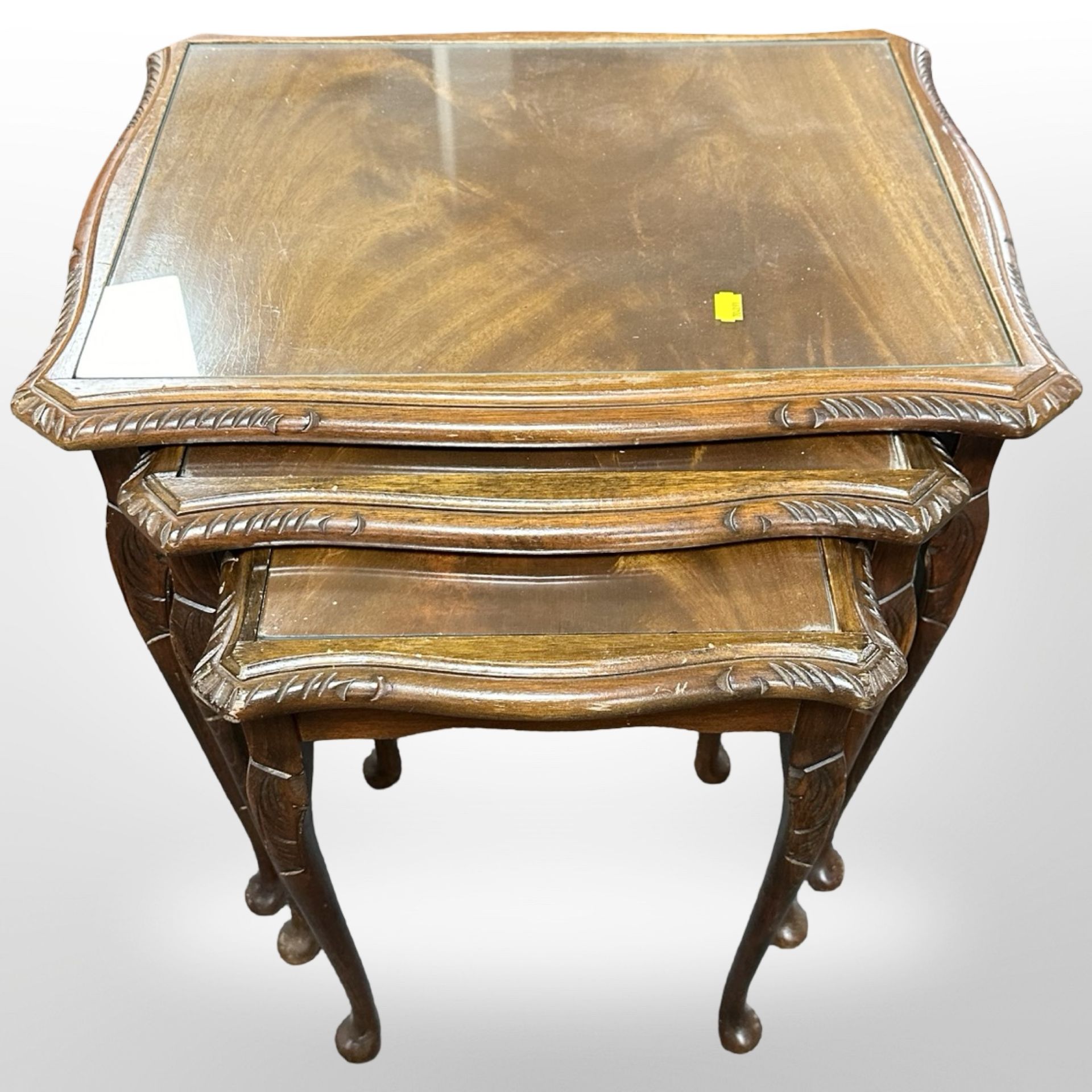 A reproduction mahogany nest of three tables,