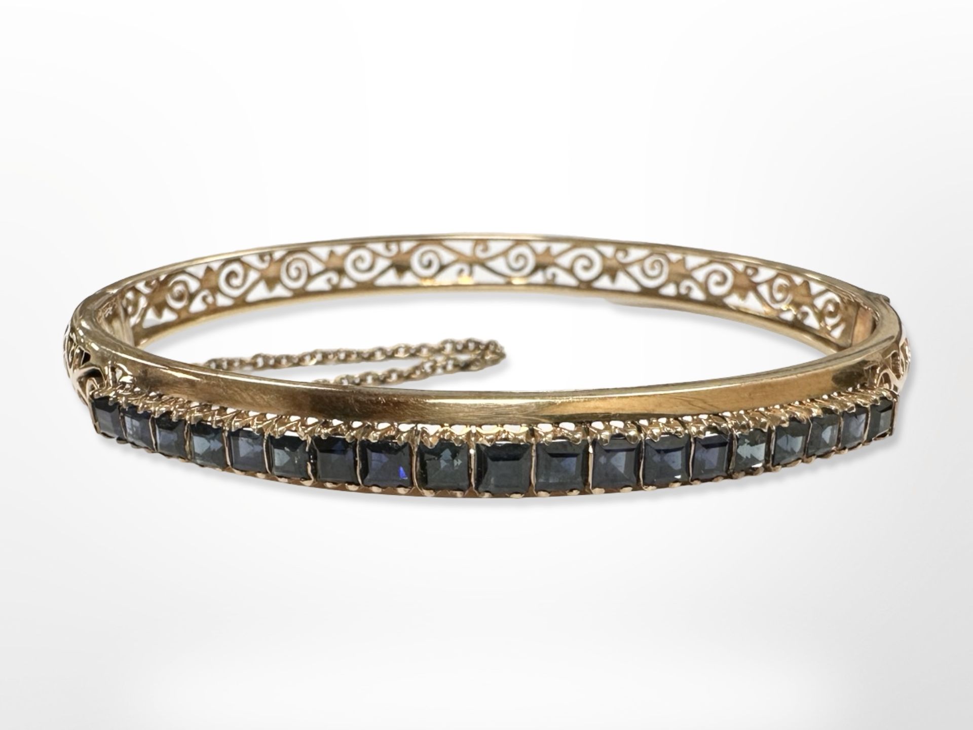 An 18ct yellow gold bangle set with sapphires, 5.5 cm x 6 cm. CONDITION REPORT: 14.