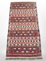 An eastern kilim runner on polychrome ground,