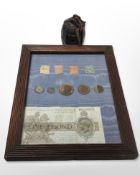 A framed montage of stamps, coins, and a £1 bank note, No.