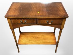 A reproduction mahogany two drawer side table,