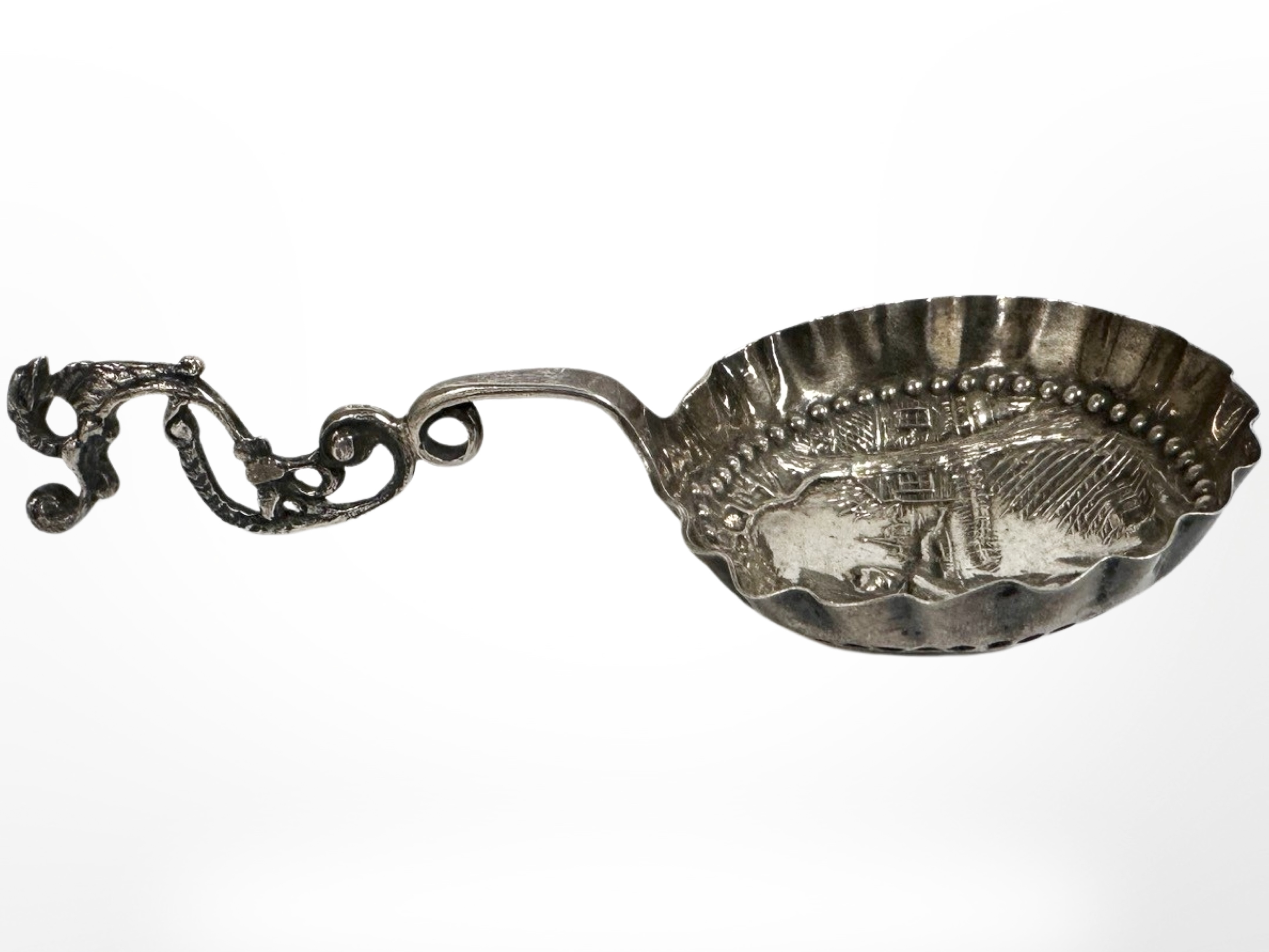 An ornate Dutch silver caddy spoon, length 12.5cm CONDITION REPORT: 25.