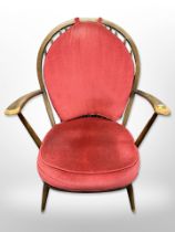 An Ercol spindle back armchair in red dralon