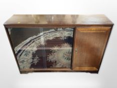 A reproduction mahogany sliding glass door bookcase,