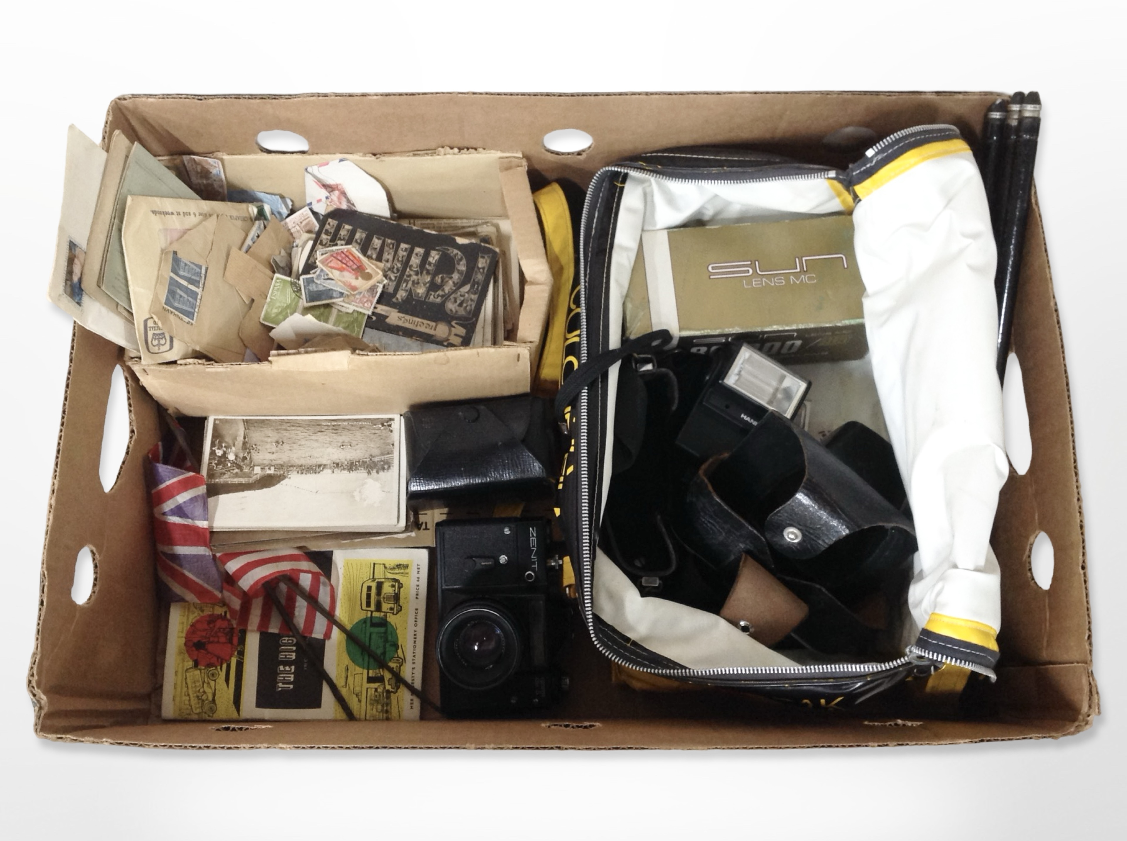 A Zenit ET camera, assorted camera accessories, antique and later postcards, loose stamps, etc.