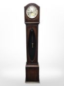 An early-20th century oak grandmother clock with silvered dial, height 142cm.