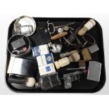 A group of items relating to smoking including lighters, pipes, etc.