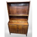 A Danish stained teak and pine open bookcase, fitted cupboards beneath,