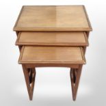 A teak nest of three tables,