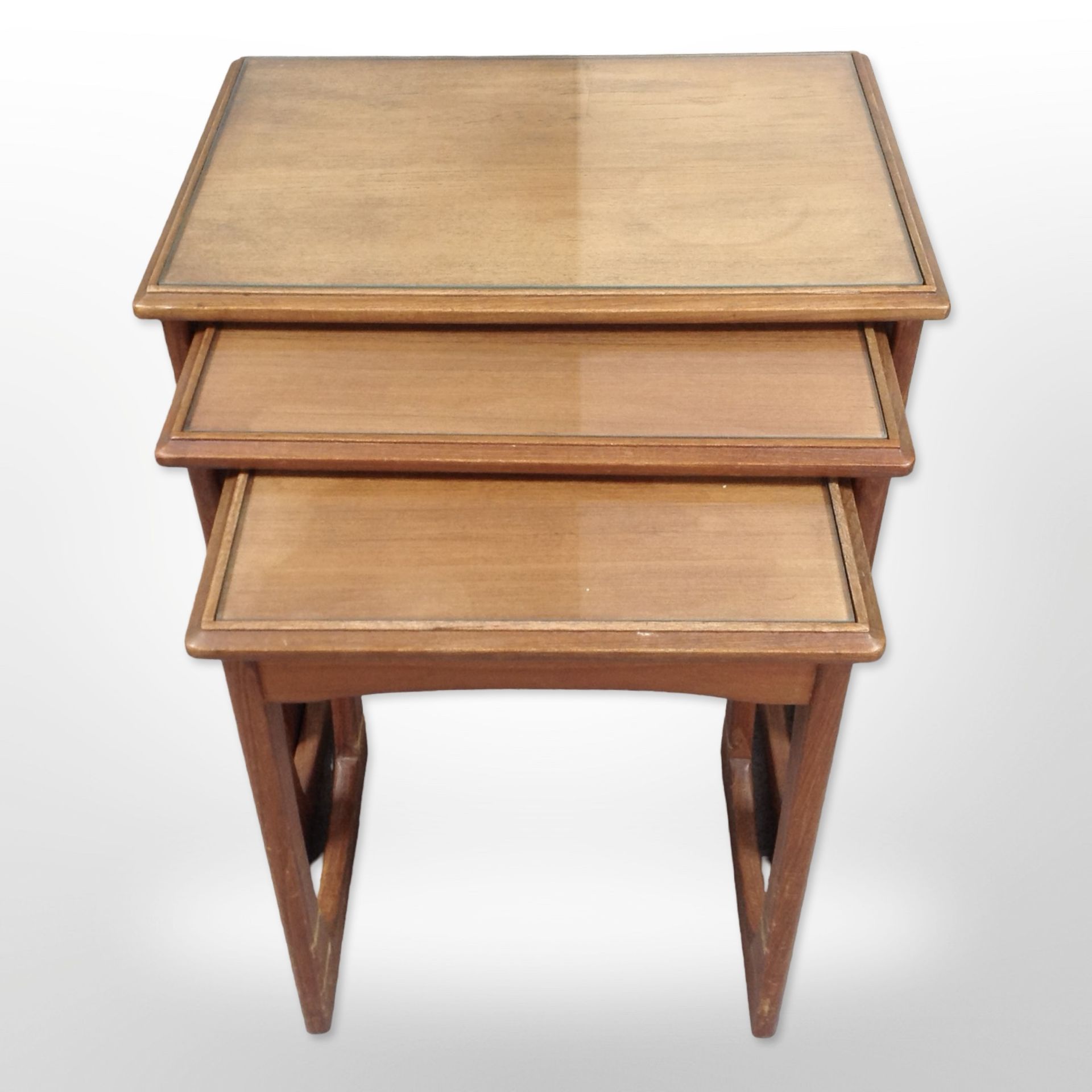 A teak nest of three tables,