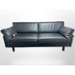A contemporary Scandinavian black stitched leather three-seater settee,