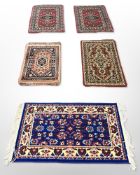 Five various machine-made Persian mats,