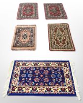 Five various machine-made Persian mats,