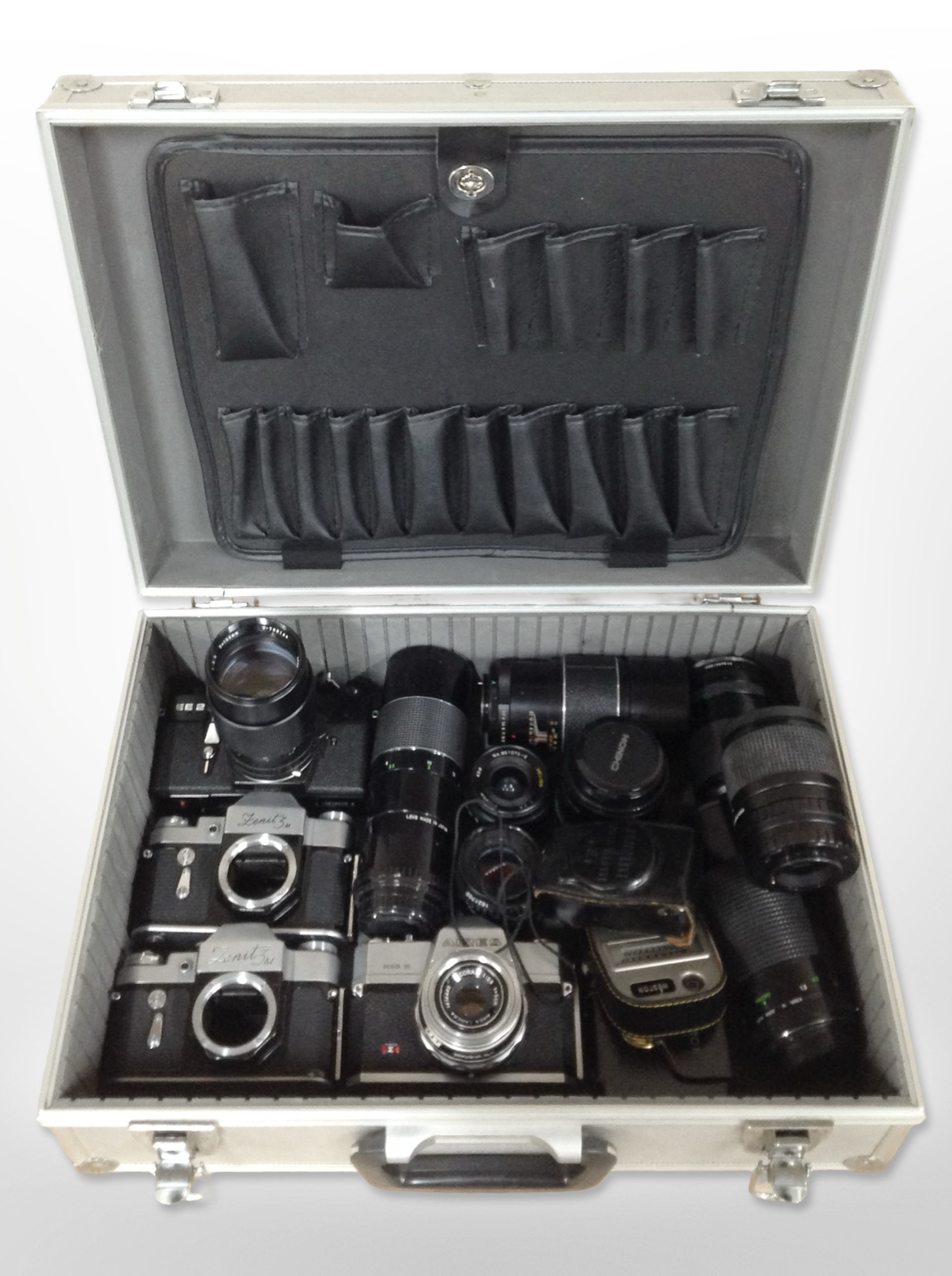 An aluminium camera case containing assorted cameras and lenses including Praktica, Zenit, Aires,