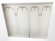 A French style cream and gilt bedroom suite comprising pair of double door wardrobes,