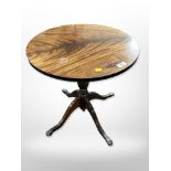 A reproduction mahogany circular pedestal table,