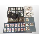 A collection of cigarette cards, loose and in albums.