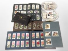 A collection of cigarette cards, loose and in albums.