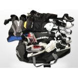 A collection of ice hockey equipment including ice skates, protective leg guards and vests, etc,