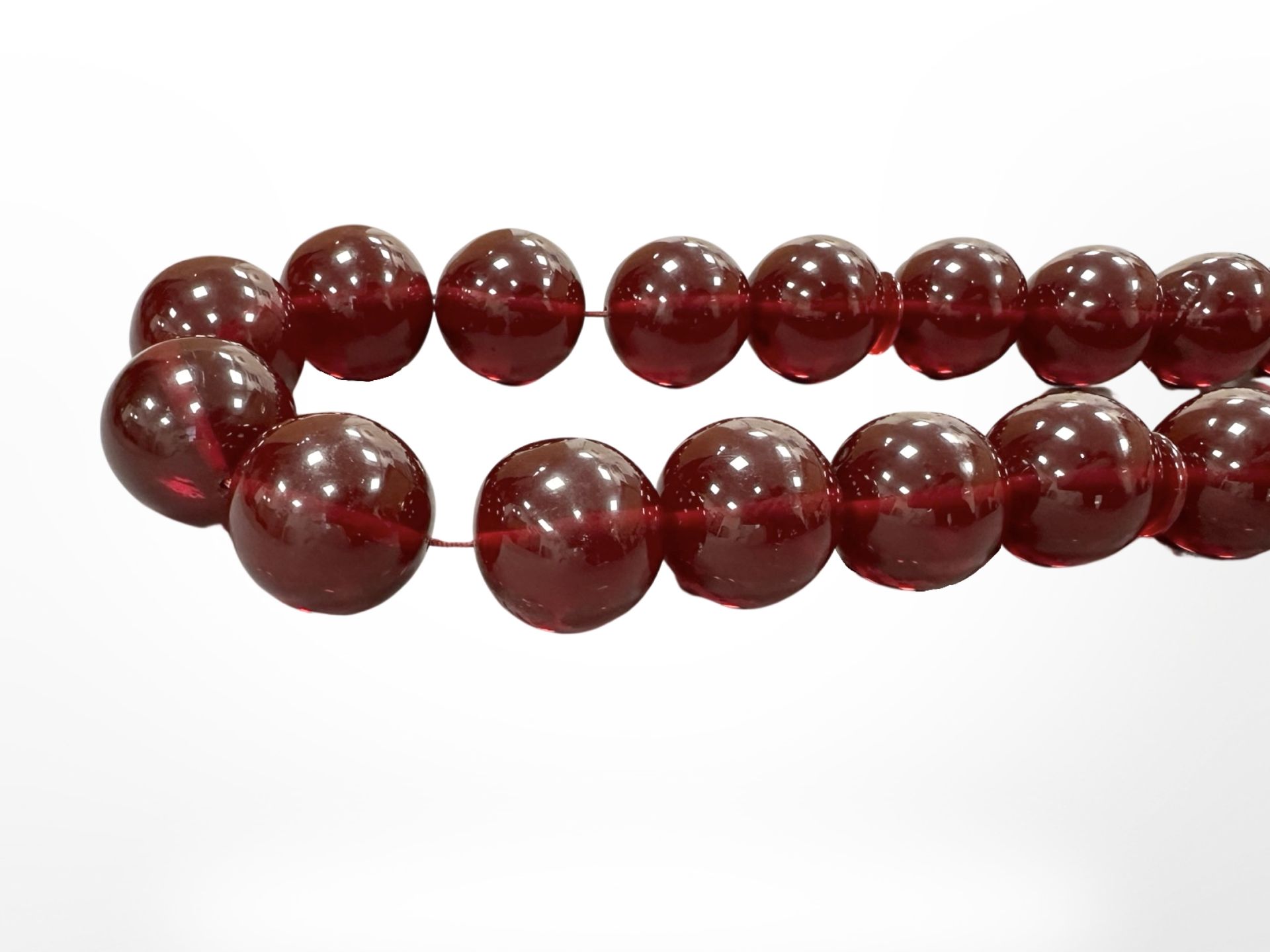 An impressive large cherry amber necklace with thirty three large spherical beads, - Image 4 of 4