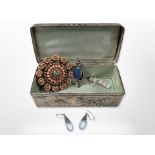 An Oriental style jewellery box with silk lining decoated with a parrot amongst foliage,